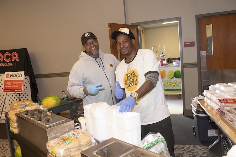 Malcolm and Dammien prepare food at an event