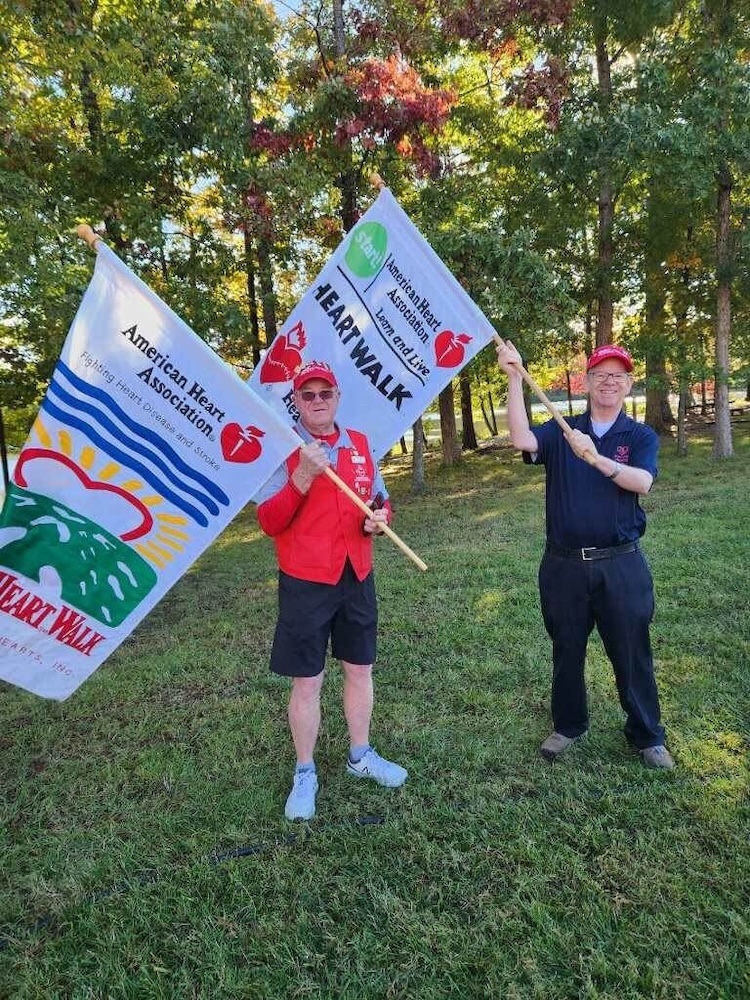 Two men holding flags at the Heart Walk.