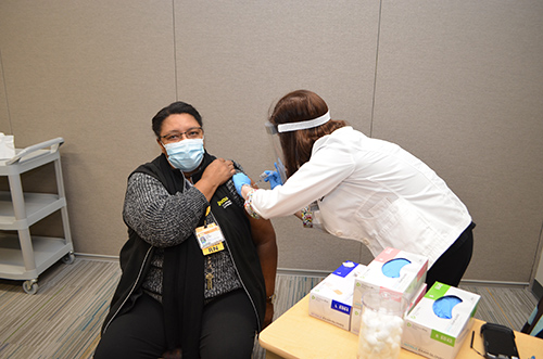 Stacy Davis vaccinates Linda Norman from Dundas, Virginia.