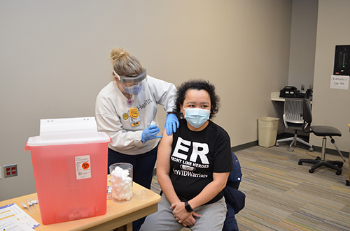 Jessica Johnson vaccinates Ma Lorie Ann Tagabucba from Mecklenburg County, a front-line ER nurse. 