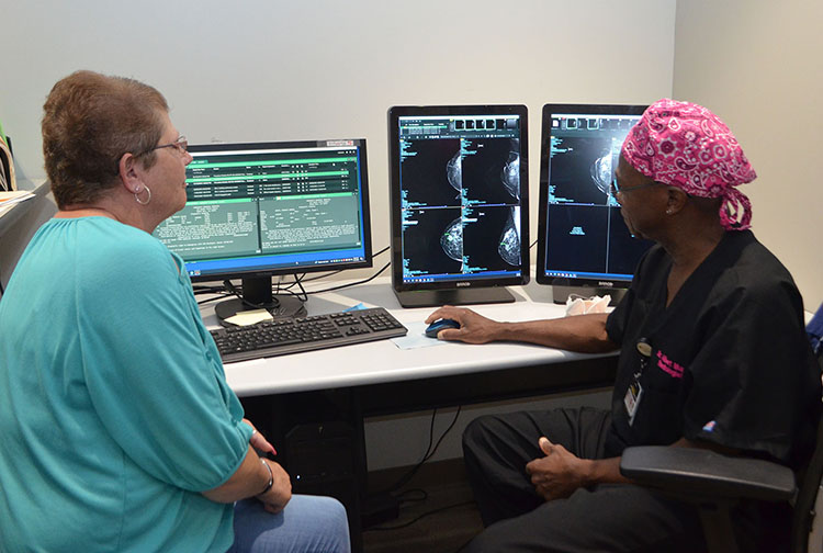 A radiologist consults with a patient after a mammogram.