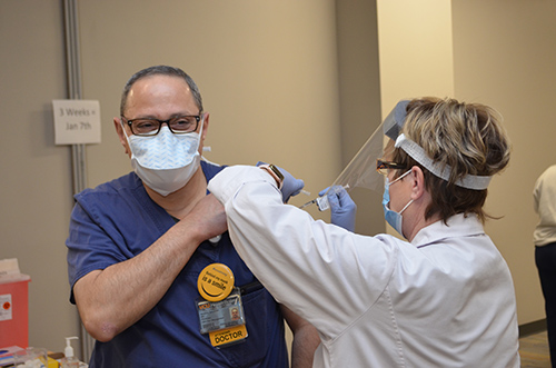 Jackie Daniel vaccinates Manhal Saleeby, MD, of Emporia, Virginia.