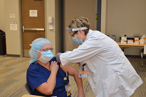 Jackie Daniel vaccinates Maryann Johnston of Halifax County, North Carolina. She is the Perioperative Services Director at VCU Health CMH.