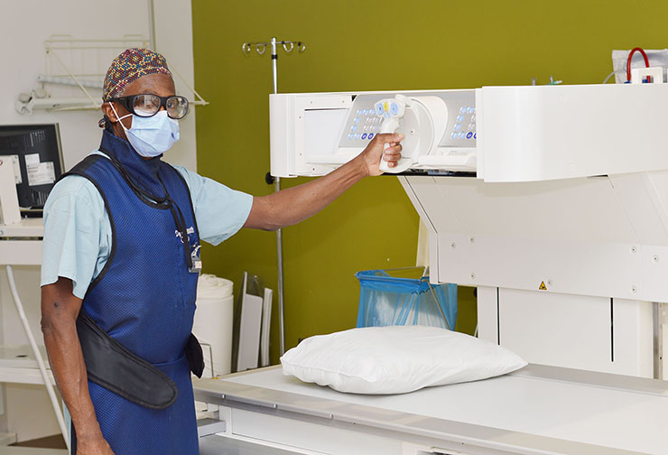 Dr. Mungo operates a fluoroscopic imaging system which uses X-rays to provide real-time moving images of the inside of the body.