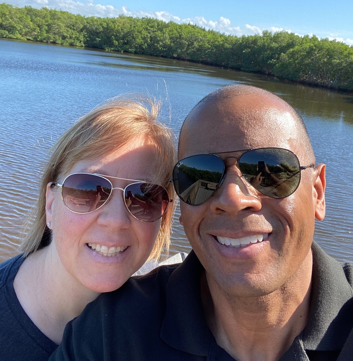 Patrick Nana Sinkam and his wife take a selfie near a lake