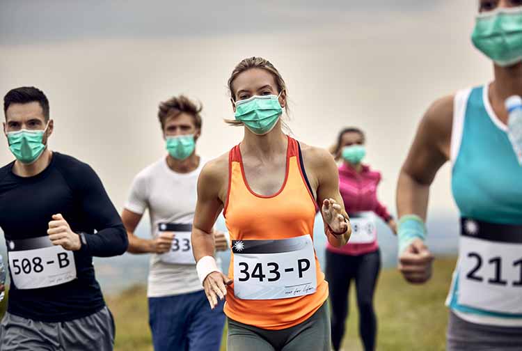 Runners in a race wearing masks