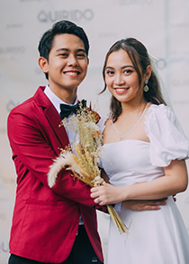 A man and woman from the Philippines pose for a marriage photo.