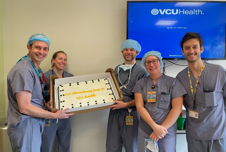 Dr. Lorenzo Azzalini and team celebrate the 100th atherectomy with cake  