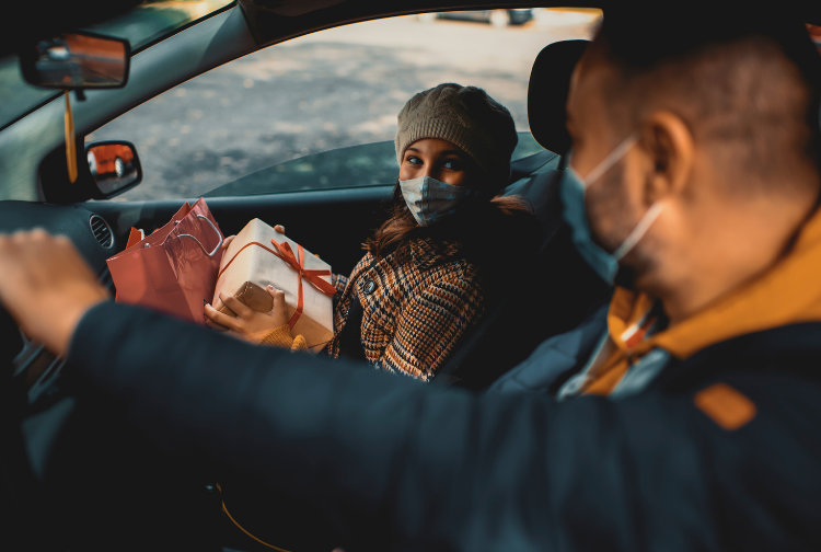 Couple in car wearing masks