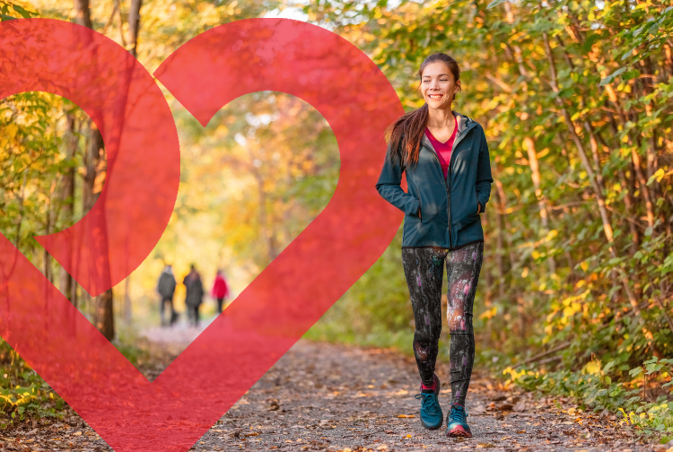 Woman Walking in the fall with Pauley Heart logo in the background