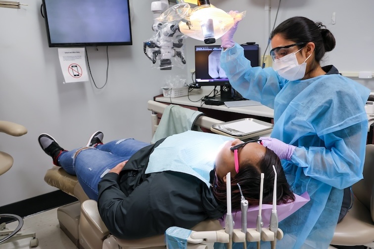Dentist prepares patient for exam