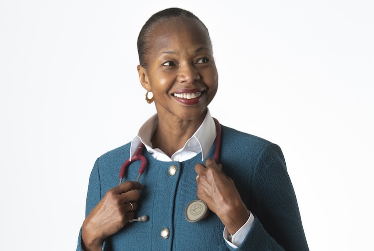 woman smiling with a doctor’s stethoscope