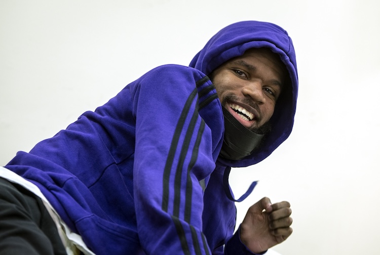 Man smiling in a purple hoodie 