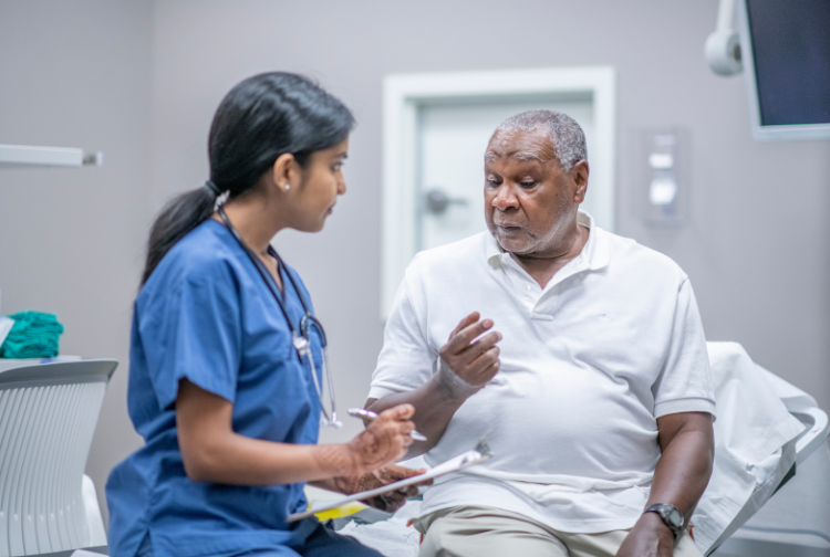 Elderly Male Patient Talking with Female Doctor