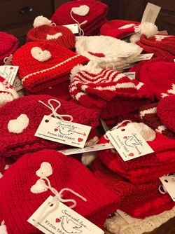 Photo of handmade red hats with white hearts