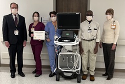 Vascular lab team members Todd Howell, Amanda Santore, Missy Watson, Albert Mungo and Donna Jarrell stand with a scanner from the Vascular Lab.