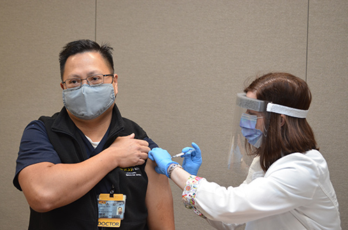 Stacy Davis vaccinates Desiderio Rimon, MD, of South Hill, Virginia. 