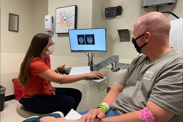 Family Nurse Practitioner Lauren Story shows patient Jeff Eastman the results of an MRI. Image shared by Jeff Eastman