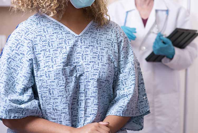 Woman wearing examination gown