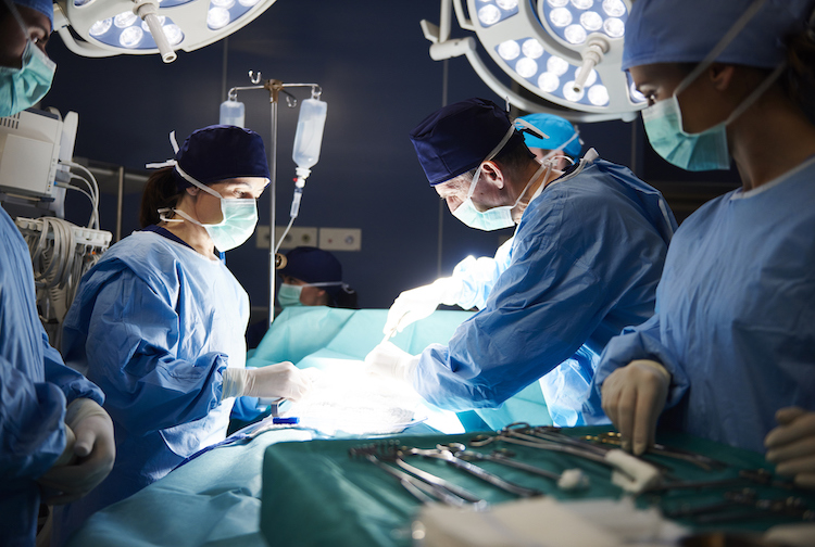 Staged photograph of doctors and nurses performing a surgery