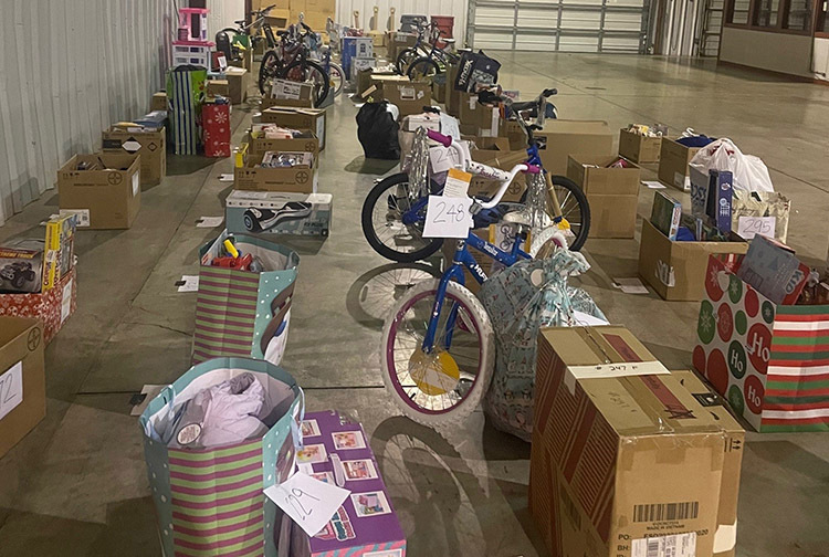 Boxes filled with toys and bikes line up a storage room at CMH