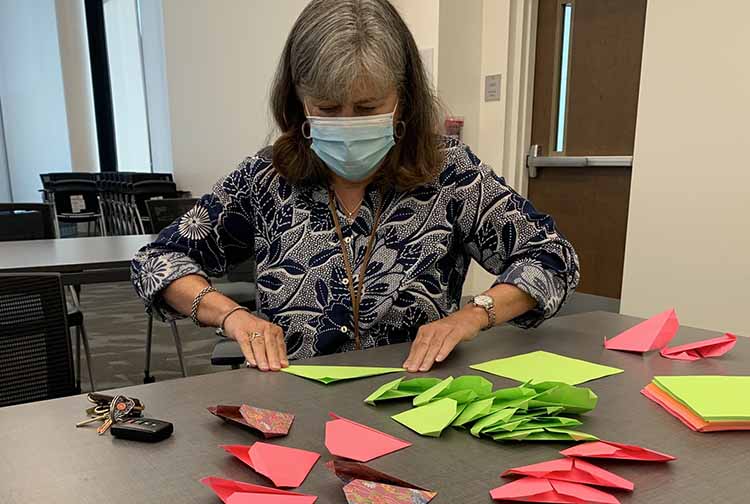 Woman making origami hearts