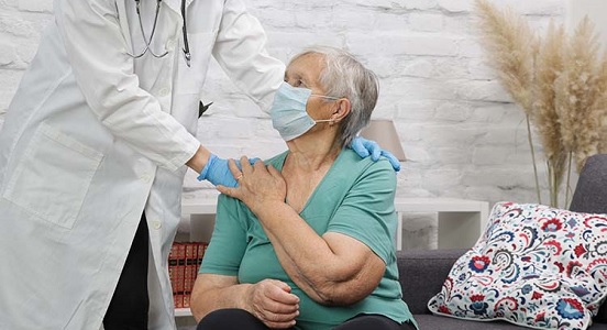 Doctor comforting an elderly patient