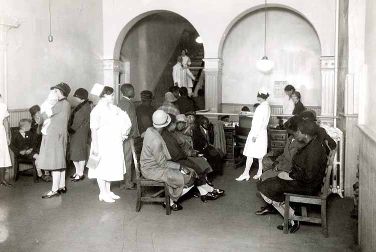 Outpatient waiting room in the old Virginia Hospital at the Medical College of Virginia , with white patients on one side and African American patients on the other. 