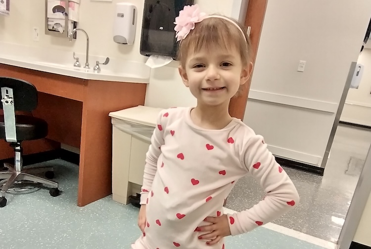 little girl in pajamas smiling 