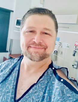 Headshot of Jason Bright in a hospital room