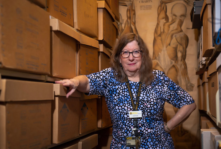 Woman standing among archives