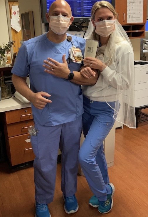 Man and woman in scrubs smiling.