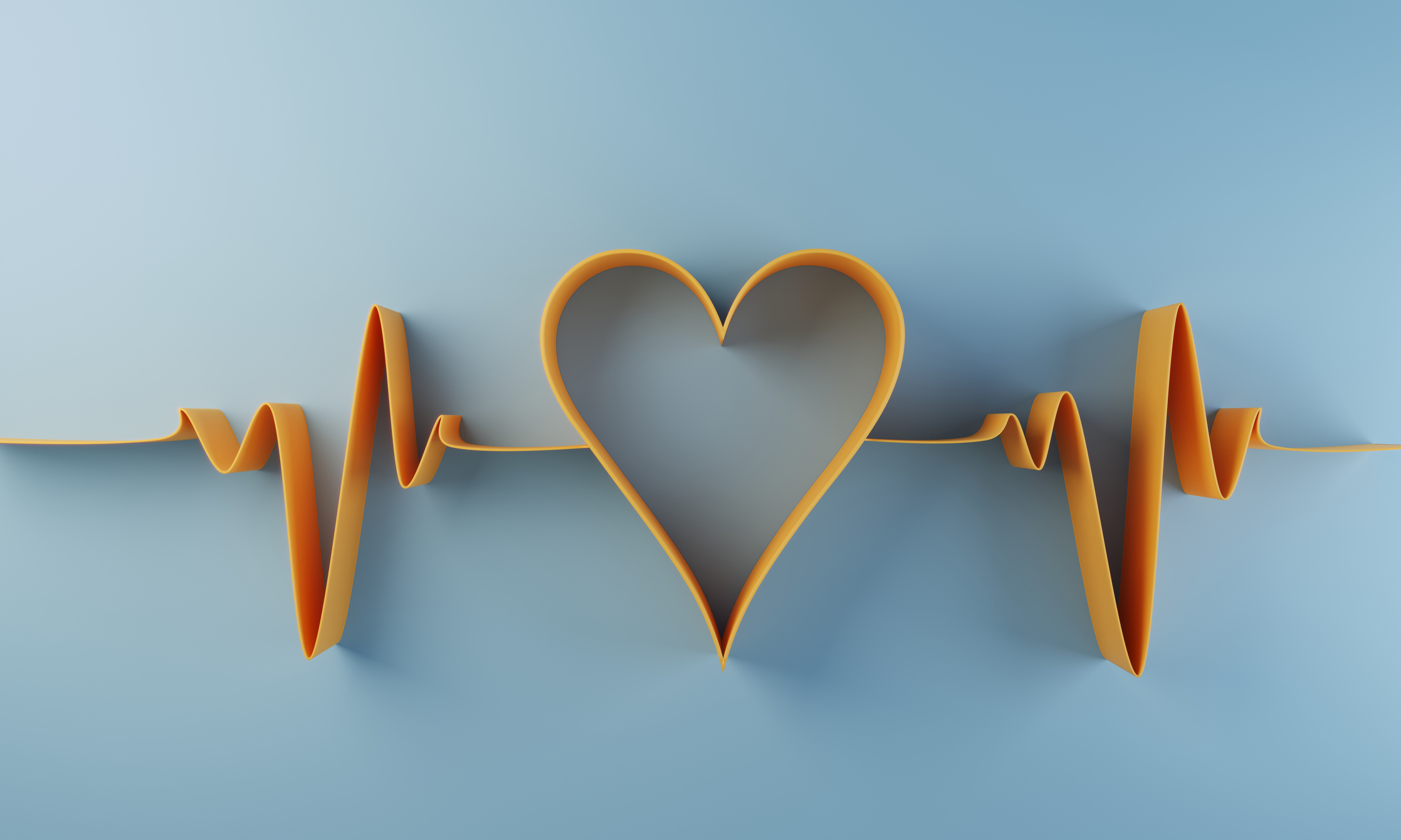 A yellow paper heart and heartbeat lines on a blue background