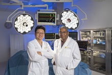 Smiling doctors standing next to each other in operation room