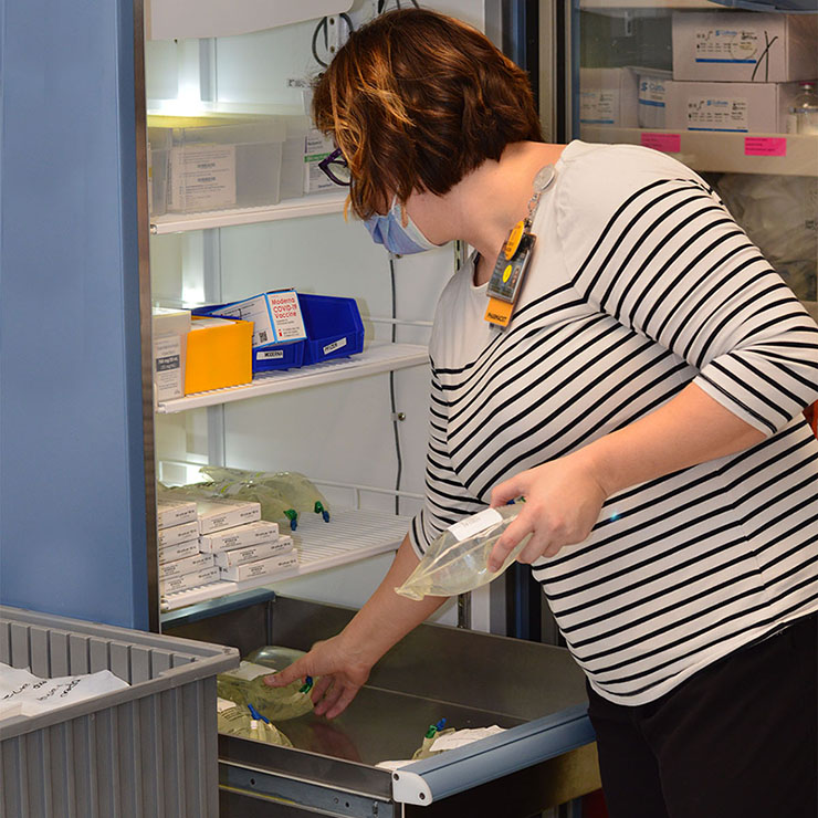 Stacey Preddy, Pharm.D, removes medication from the fridge for use in a patient room. Stacey lives in Palmer Springs and has been employed at VCU Health CMH for 14 years.