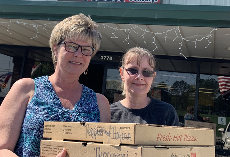 Brenda Harris, left, and Tammy Ownby from Top This Pizza made pizzas for VCU Health CMH's Emergency Department and ICU on Monday.