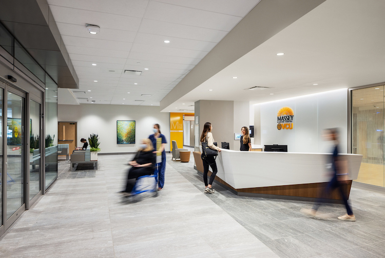 Patients and caregivers walk through the entrance of VCU Massey Cancer Center in the VCU Health Adult Outpatient Pavillion.
