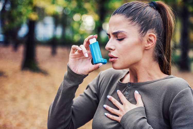 woman using an inhaler resized