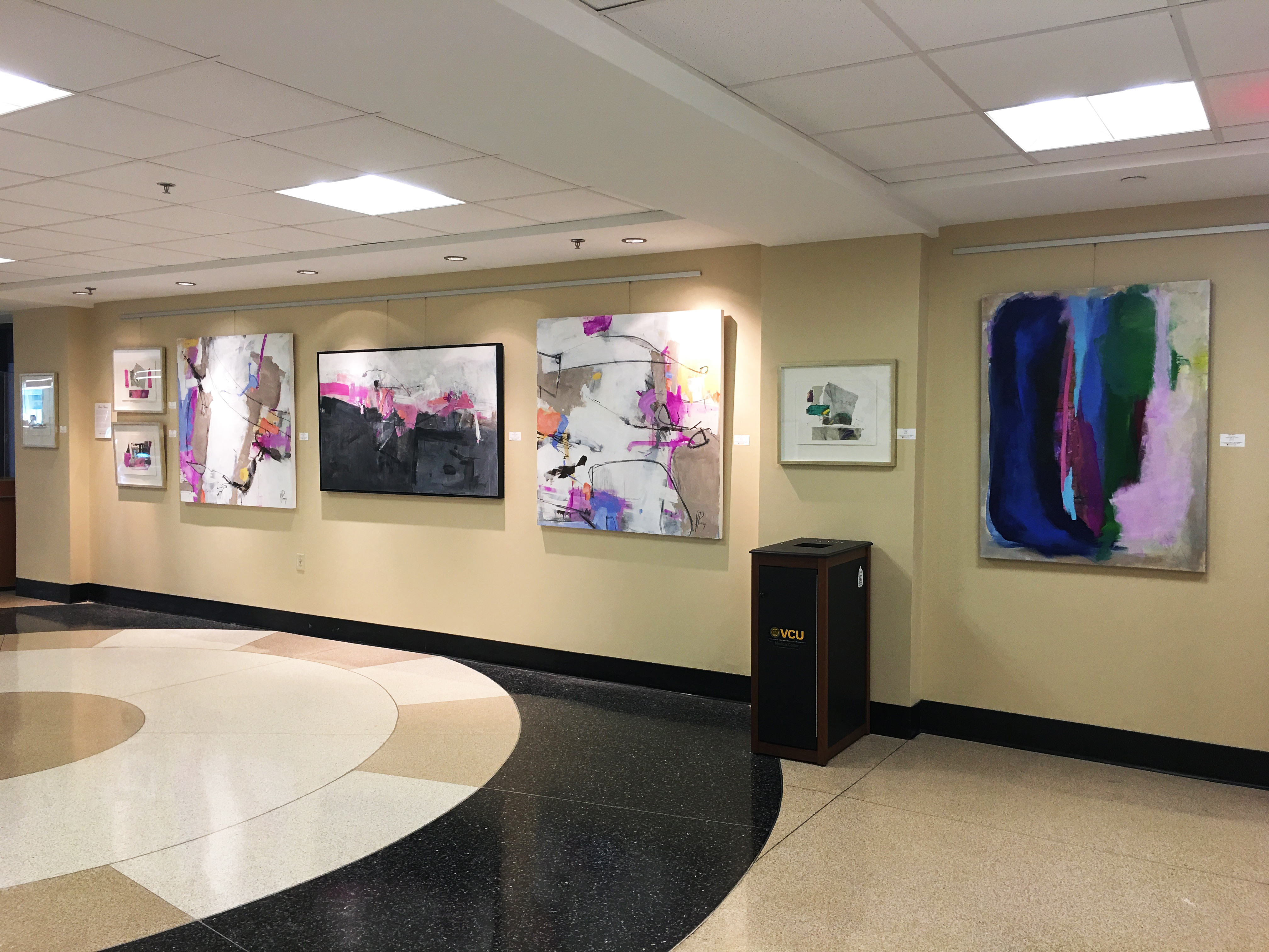 Image of paintings by artist Jaine Pinney hanging in the VCU Medical Center Gateway Gallery