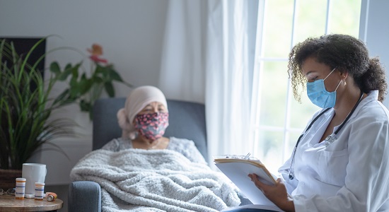 Doctor talking with a patient while both wear masks