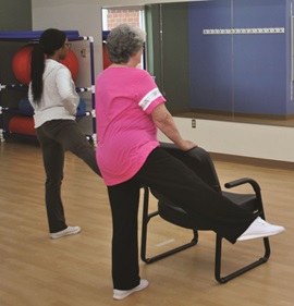 Two people performing rehab therapy