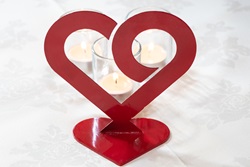 Image of red heart in front of lit candles