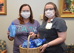 A lady donates Mary Kay products for a nurse to give to cancer patients