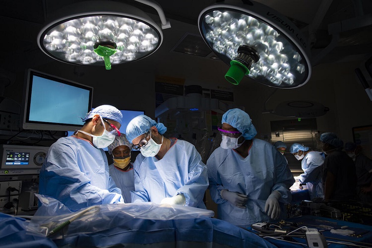 Transplant surgery team performing operation on a patient in OR