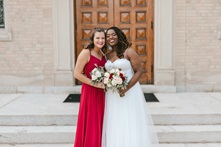 Two women at a wedding celebrate