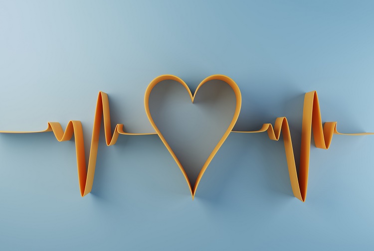 A yellow heart and heartbeat made of paper on a blue background