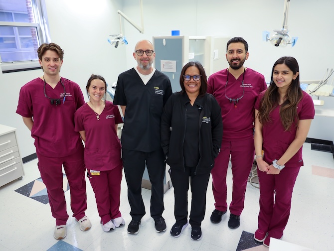 Group of students with faculty at dental clinic.