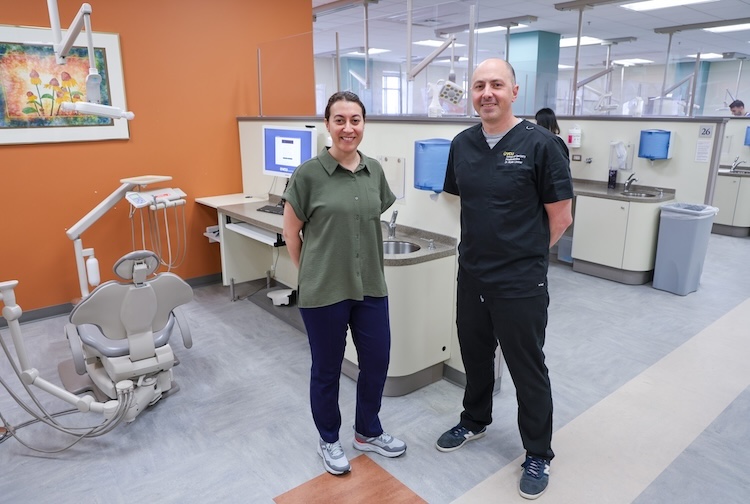 Two dentists standing together in scrubs