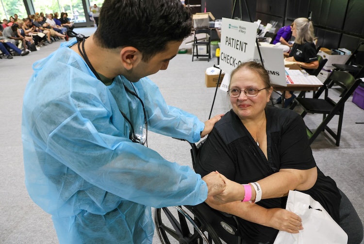 Dentist shakes hand of patient at event