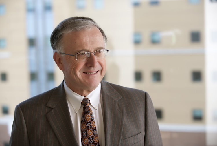 John Duval in a grey suit with a pattern tie.